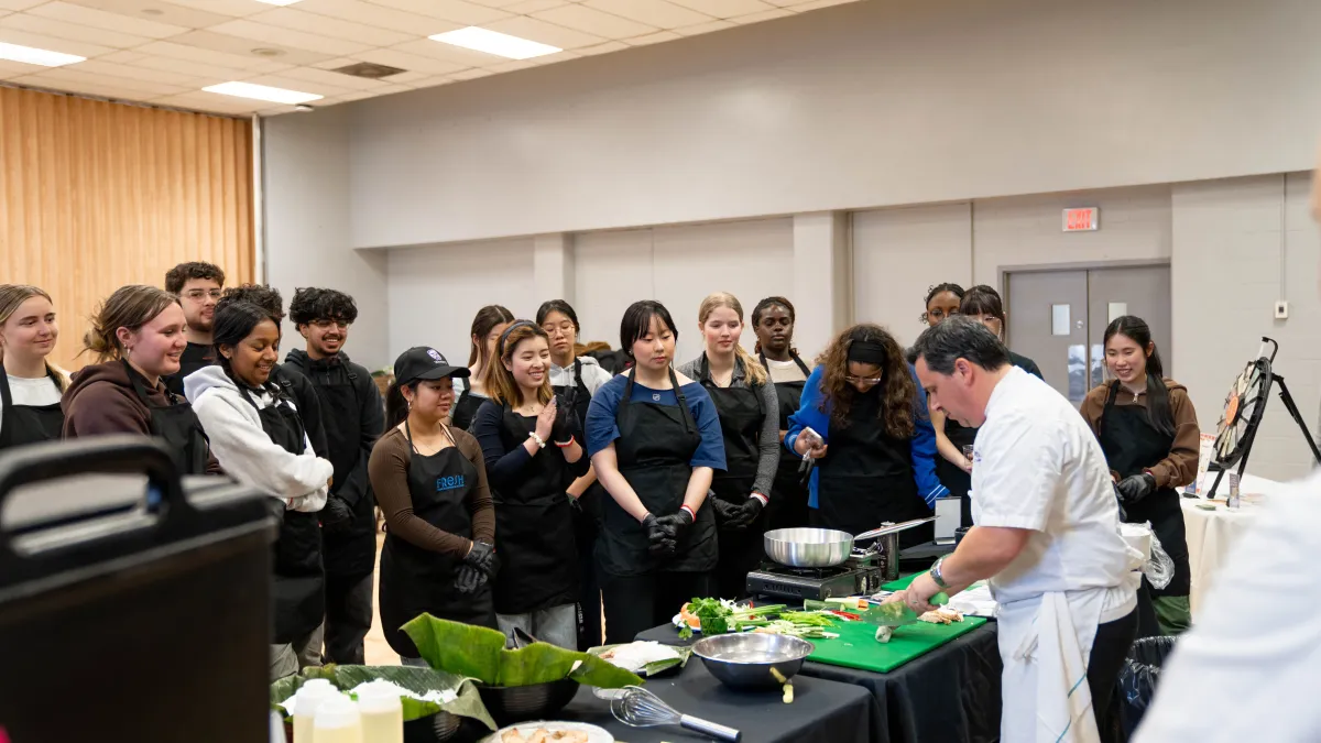 Chef teaching students knife skills