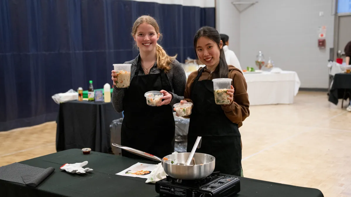 Students holding the food they made