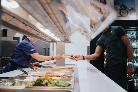 Student being served food in residence